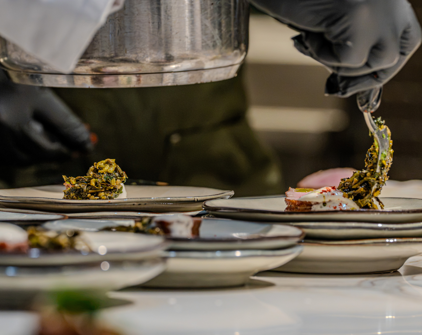 A chef plating a dish. 